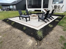 Custom paver patio with Summit Stone fire pit, Karl Foerster grass, and Elijah Blue fescue plantings in Grimes, Iowa