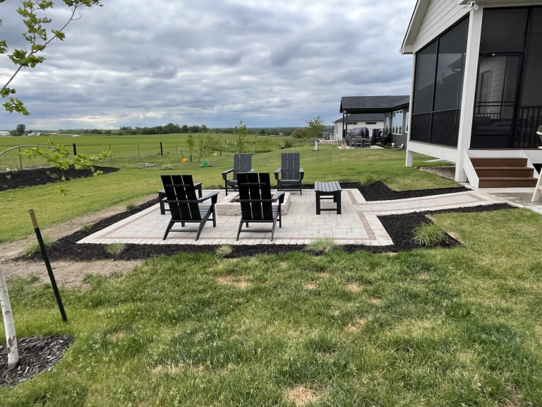 Custom paver patio with Summit Stone fire pit, Karl Foerster grass, and Elijah Blue fescue plantings in Grimes, Iowa