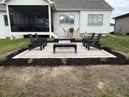 Custom paver patio with Summit Stone fire pit, Karl Foerster grass, and Elijah Blue fescue plantings in Grimes, Iowa