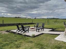 Custom paver patio with Summit Stone fire pit, Karl Foerster grass, and Elijah Blue fescue plantings in Grimes, Iowa